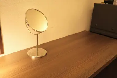 a mirror sitting on top of a wooden table at Urban House Nakano in Tokyo