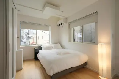a small bedroom with a bed and a window at Urban House Hatagaya in Tokyo