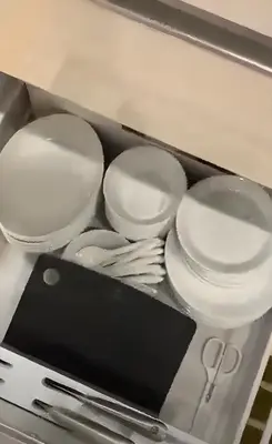 a box filled with white plates and utensils at Urban House Hatagaya in Tokyo