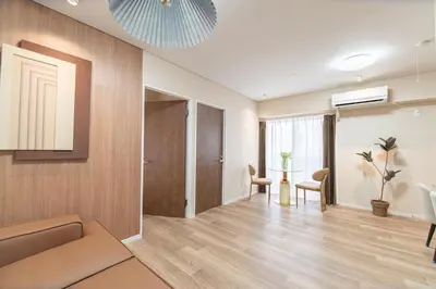 a living room with a couch and a table at Z7\u5168\u65b0\u88c5\u4fee\u5957\u623f3\u5ba42\u5385 \u65b0\u5bbf2\u7ad94\u5206\u949f,Max 8p-spacious,3rooms Near Shinjuku in Tokyo