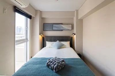 a bedroom with a bed with a large window at Z7\u5168\u65b0\u88c5\u4fee\u5957\u623f3\u5ba42\u5385 \u65b0\u5bbf2\u7ad94\u5206\u949f,Max 8p-spacious,3rooms Near Shinjuku in Tokyo