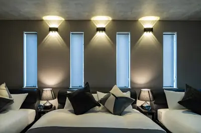 a room with a bed with lights and windows at 91, Honancho A, Entire house for rent, \u65b9\u5357\u753aA in Tokyo