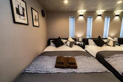 two beds sitting in a room with windows at 91, Honancho A, Entire house for rent, \u65b9\u5357\u753aA in Tokyo