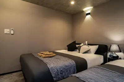 a bedroom with two beds with towels on the bed at 91, Honancho A, Entire house for rent, \u65b9\u5357\u753aA in Tokyo