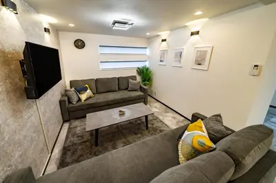 a living room with a couch and a tv at 91, Honancho A, Entire house for rent, \u65b9\u5357\u753aA in Tokyo