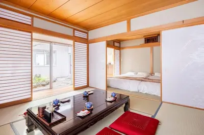 a living room with a bed and a table at Private Japanese garden,130m2, Ikebukuro Shinjuku Shibuya 5-15min , 200 restaurants nearby, 7-11 in front in Tokyo
