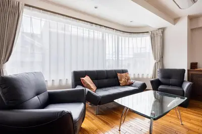 a living room with two couches and a glass table at Private Japanese garden,130m2, Ikebukuro Shinjuku Shibuya 5-15min , 200 restaurants nearby, 7-11 in front in Tokyo