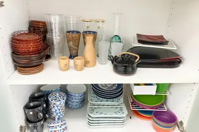 a white shelf filled with plates and vases at Private Japanese garden,130m2, Ikebukuro Shinjuku Shibuya 5-15min , 200 restaurants nearby, 7-11 in front in Tokyo