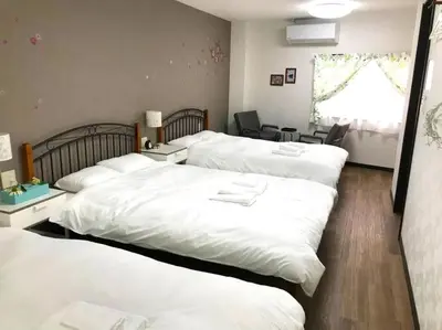 a bedroom with three beds with white sheets at 13, Yotsugi 1, Entire house for rent, \u56db\u3064\u67281 in Tokyo