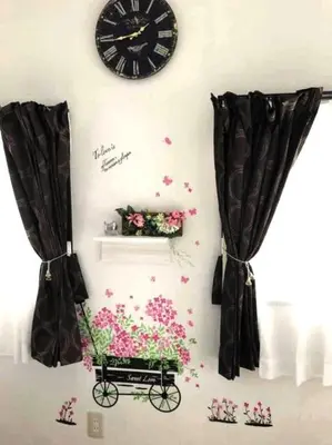 a wall with a clock and a cart with flowers at 13, Yotsugi 1, Entire house for rent, \u56db\u3064\u67281 in Tokyo
