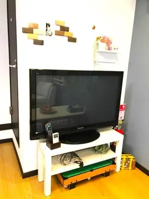 a flat screen tv sitting on a white tv stand at 13, Yotsugi 1, Entire house for rent, \u56db\u3064\u67281 in Tokyo