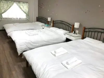 three beds in a room with white sheets at 13, Yotsugi 1, Entire house for rent, \u56db\u3064\u67281 in Tokyo