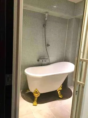 a bath tub in a bathroom with a shower at 13, Yotsugi 1, Entire house for rent, \u56db\u3064\u67281 in Tokyo