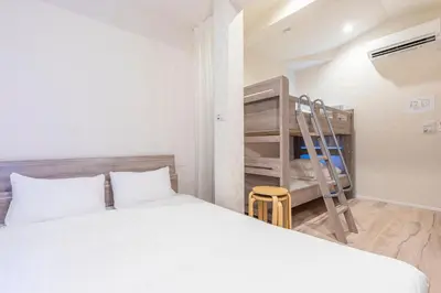 a bedroom with a bed and a bunk bed at \u30d9\u30eb\u9418 in Tokyo
