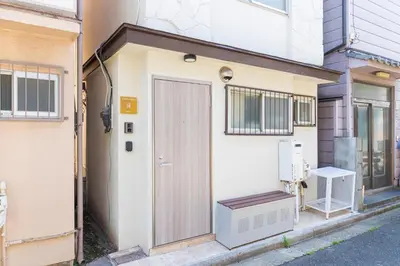 a building with a door and a bench next to it at \u30d9\u30eb\u9418 in Tokyo
