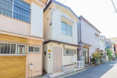 an apartment building with a door on a street at \u30d9\u30eb\u9418 in Tokyo