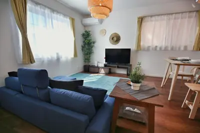 a living room with a blue couch and a tv at XD54321 The 100-square-meter super-large villa near Tokyo Skytree can accommodate 8 people! in Tokyo