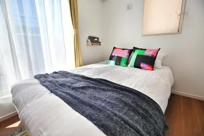 a bedroom with a bed with pillows and a window at XD54321 The 100-square-meter super-large villa near Tokyo Skytree can accommodate 8 people! in Tokyo