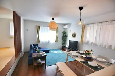a living room with a blue couch and a table at XD54321 The 100-square-meter super-large villa near Tokyo Skytree can accommodate 8 people! in Tokyo