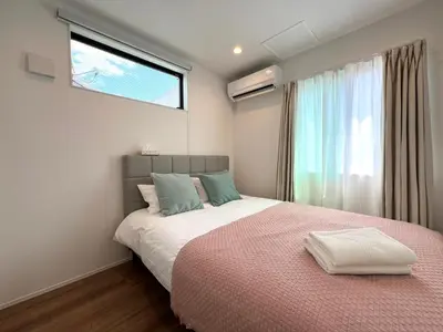 a bedroom with a large bed with a window at Shibuya House-SY0108 in Tokyo