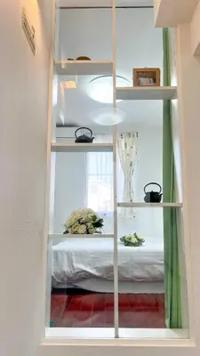 a book shelf with a bed in a room at JING HOUSE Shintakasago - Vacation STAY 17117 in Tokyo