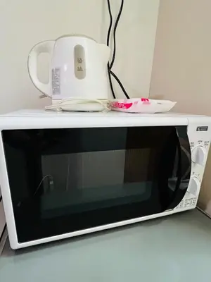 a microwave with a tea kettle on top of it at Lucerne - Vacation STAY 17128 in Tokyo