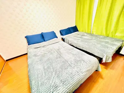 two beds with blue pillows in a room at Lucerne - Vacation STAY 17128 in Tokyo