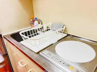a kitchen with a dish drying rack next to a dishwasher at Lucerne - Vacation STAY 17128 in Tokyo