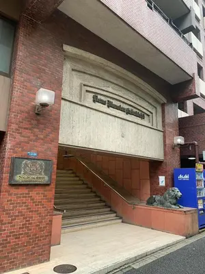 a dog sitting in front of a building at Lions B in Tokyo