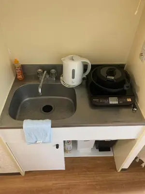a kitchen counter with a sink and a microwave at Lions B in Tokyo
