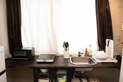 a kitchen counter with a sink and a window at -花雷 はならい in 浅草&雷門- 浅草駅から徒歩5分 ベビー用品付き ファミリーも歓迎 大人8名もOK!! in Tokyo