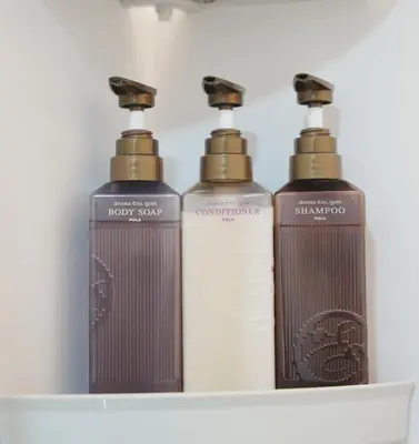 a group of three shampoo bottles sitting on a shelf at \u6771\u4eac\u30ea\u30ea\u30a2\u30eb\u30db\u30c6\u30eb 301 in Tokyo
