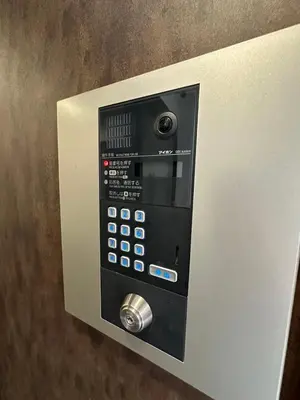 a vending machine with a control panel on a wall at SOLASIA residence \u5317\u4e0a\u91ce601 in Tokyo