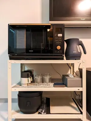 a microwave sitting on top of a shelf at Space Noa201 in Tokyo