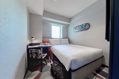 a small room with a bed and a desk at lyf Shibuya Tokyo in Tokyo