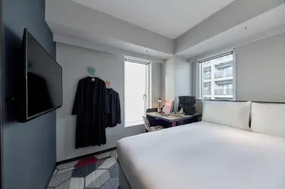a hotel room with a bed and a window at lyf Shibuya Tokyo in Tokyo