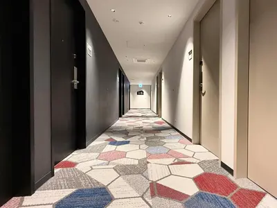 a hallway with a tile floor in a building at lyf Shibuya Tokyo in Tokyo
