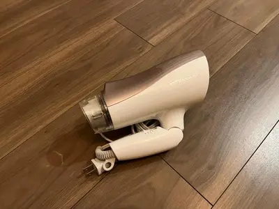 a hair dryer sitting on a wooden floor at The FLAT 103 in Tokyo