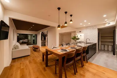 a kitchen and living room with a large wooden table at Villa Shibuya East , \u6e0b\u8c37\u6771\u30f4\u30a3\u30e9 in Tokyo
