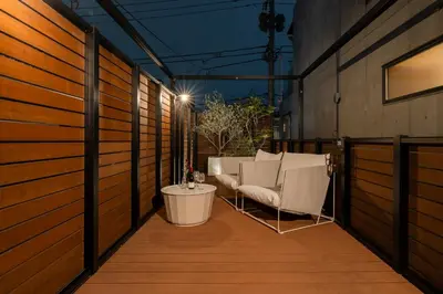 a balcony with chairs and a table on a building at Villa Shibuya East , \u6e0b\u8c37\u6771\u30f4\u30a3\u30e9 in Tokyo