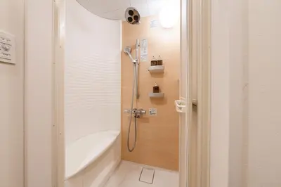 a bathroom with a shower and a bath tub at Villa Shibuya East , \u6e0b\u8c37\u6771\u30f4\u30a3\u30e9 in Tokyo