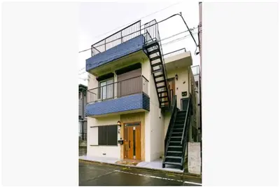 a building with a spiral staircase on the side of it at 64, Shiomi , Second floor of the apartment, \u6f6e\u898b2F in Tokyo