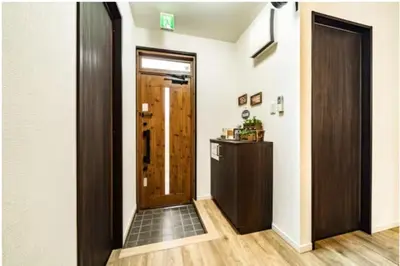 a hallway with a wooden door and a floor at 64, Shiomi , Second floor of the apartment, \u6f6e\u898b2F in Tokyo