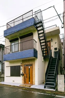 a building with a staircase on the side of it at 63, Shiomi, First floor of the apartment, \u6f6e\u898b1F in Tokyo