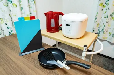 a coffee maker on a table next to a spatula at 63, Shiomi, First floor of the apartment, \u6f6e\u898b1F in Tokyo