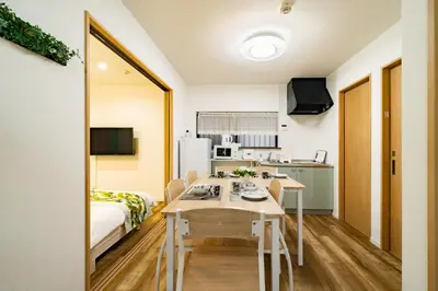 a small apartment with a table and a kitchen at 63, Shiomi, First floor of the apartment, \u6f6e\u898b1F in Tokyo