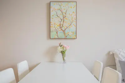 a white table with a vase of flowers on it at The best choice for accommodation in Yoyogi SoYk in Tokyo