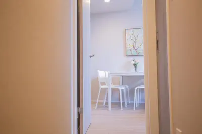 a room with a table and a white table and chairs at The best choice for accommodation in Yoyogi SoYk in Tokyo