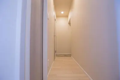 a hallway with a door leading to a room with white walls at The best choice for accommodation in Yoyogi SoYk in Tokyo