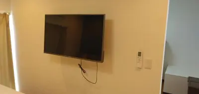 a flat screen tv hanging on a wall at 79, Umejima, Entire house for rent, \u6885\u5cf6 in Tokyo